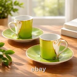 A Pair of Christian Lacroix France Follement Green Demitasse Cup and Saucer Set