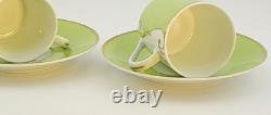 A Pair of Christian Lacroix France Follement Green Demitasse Cup and Saucer Set