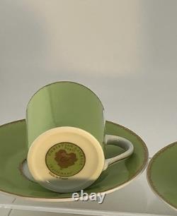 A Pair of Christian Lacroix France Follement Green Demitasse Cup and Saucer Set
